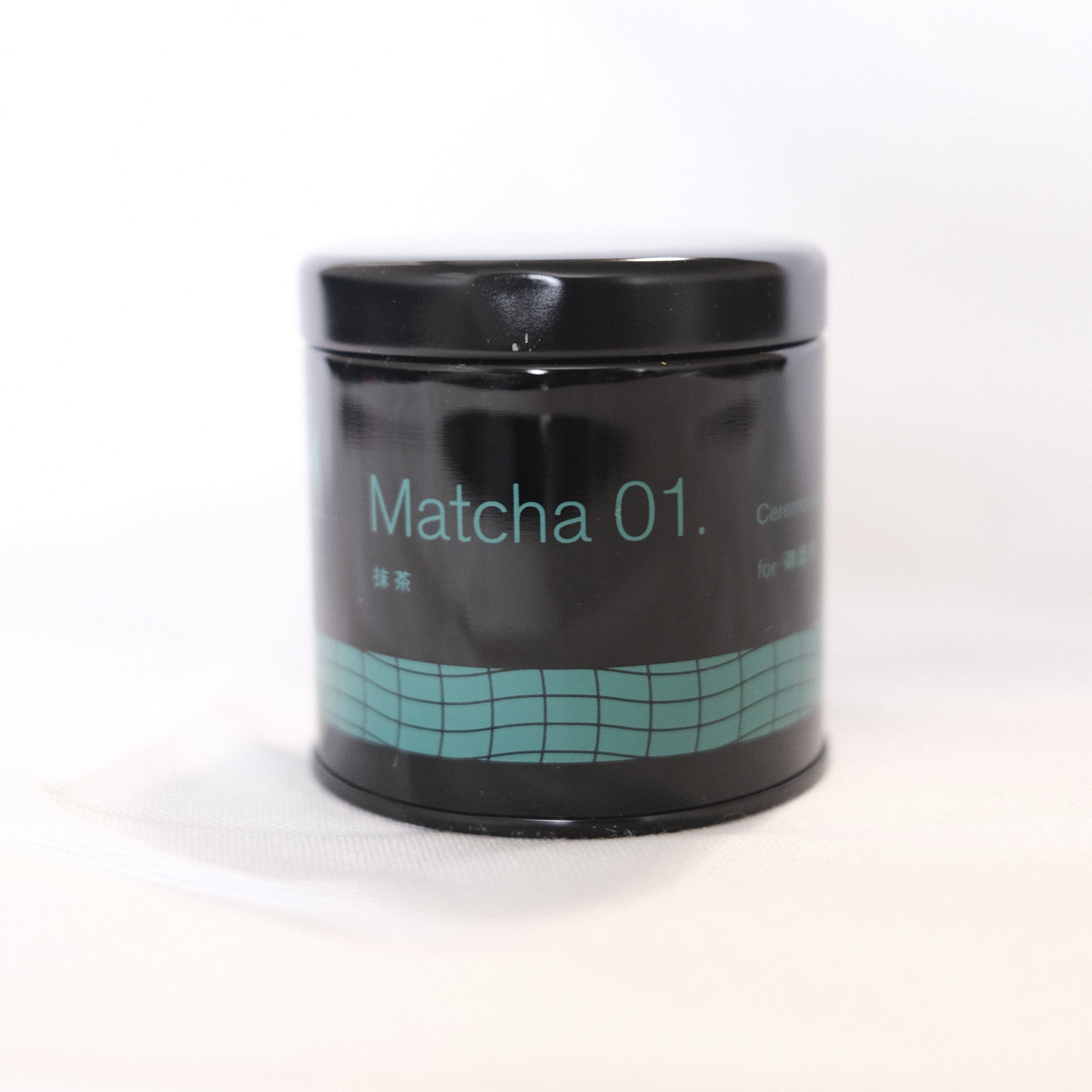 Jar of Matcha 01 powder on a white background