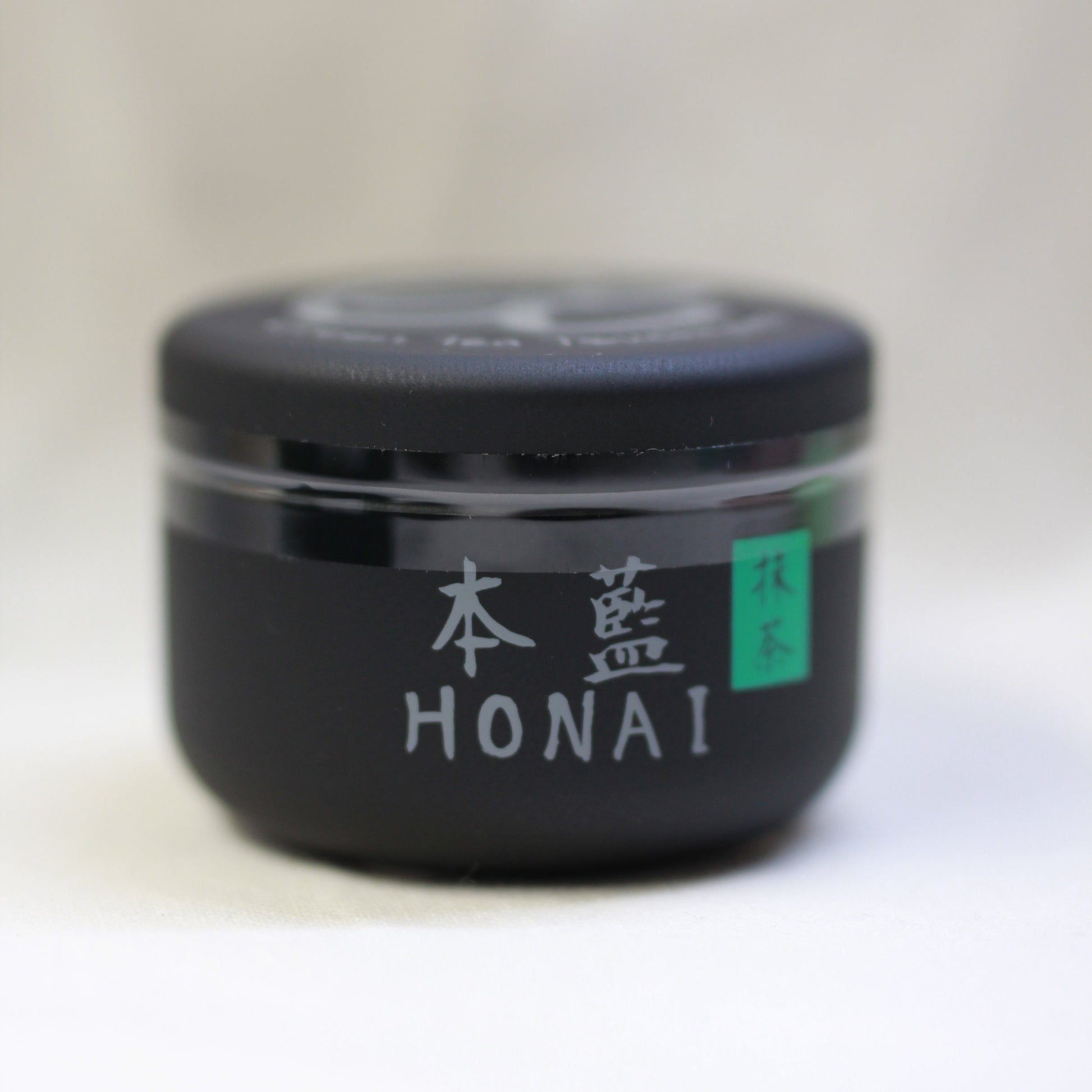 Black container with 'HONAI' branding on a white background